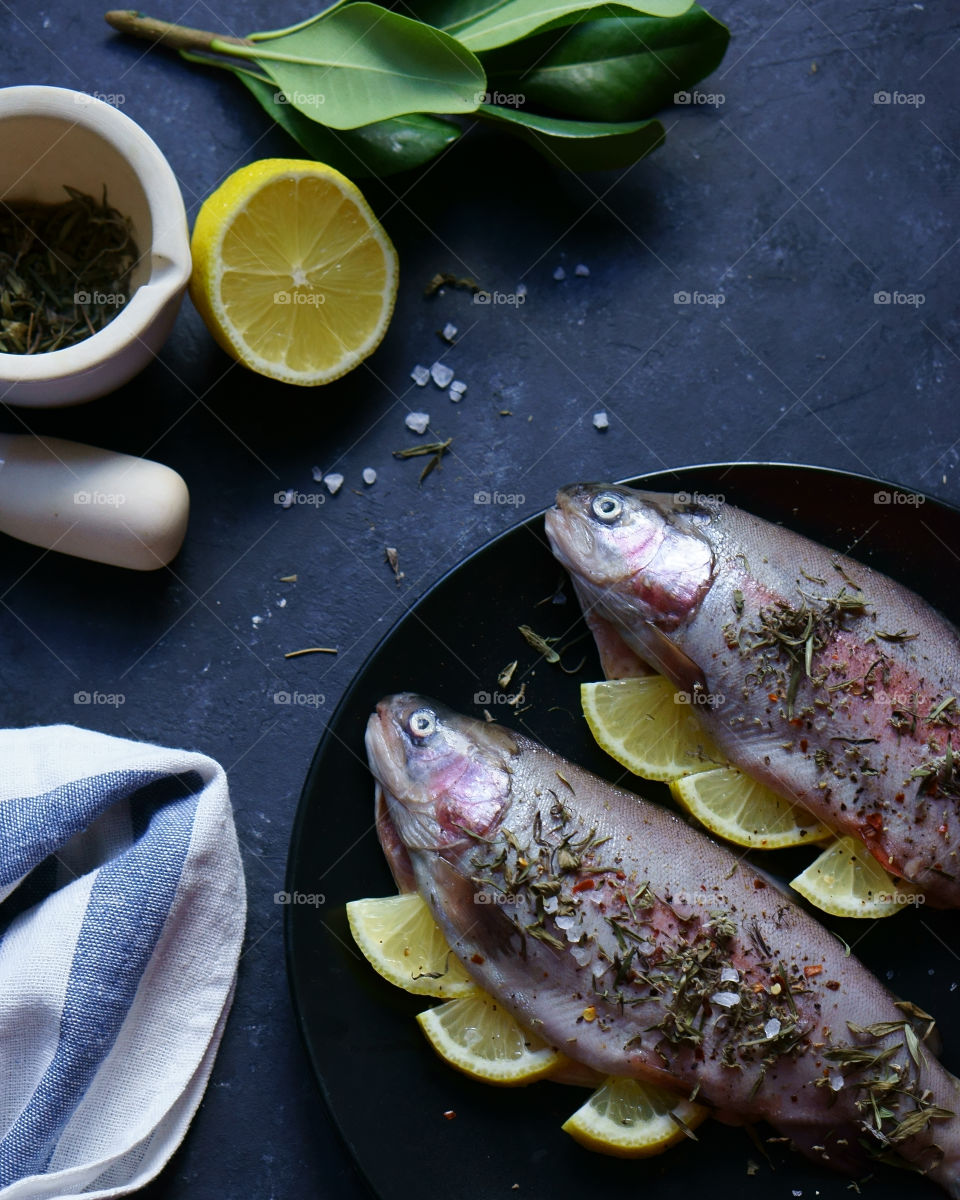 High angle view of salmon fish with lemon slice