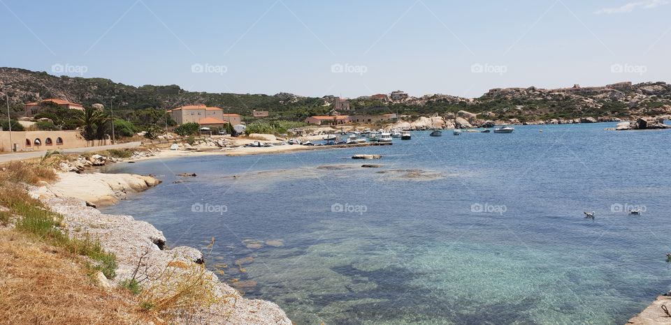 Little lagoon in Sardinia with Fisher village in the background