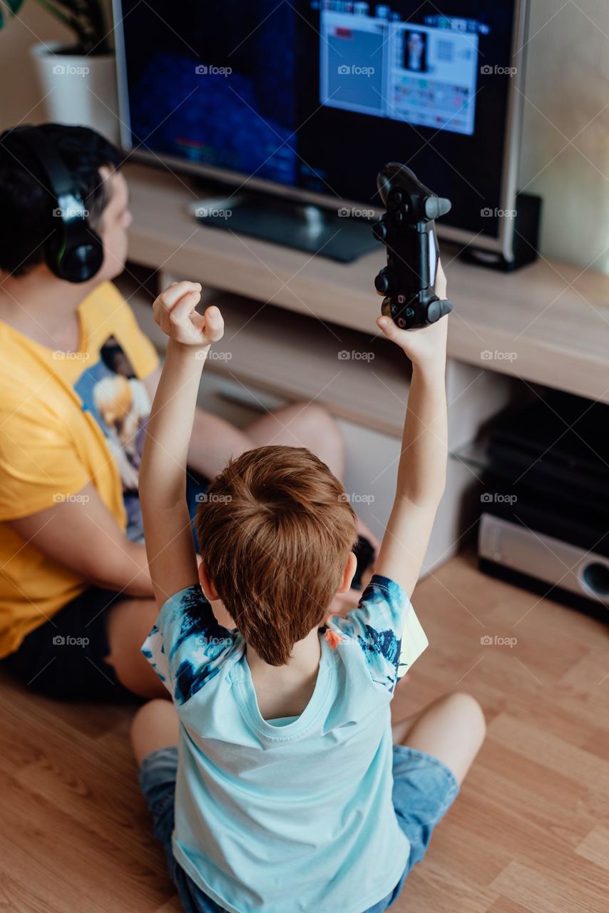 Red-haired boy with his father watches a 3d movie