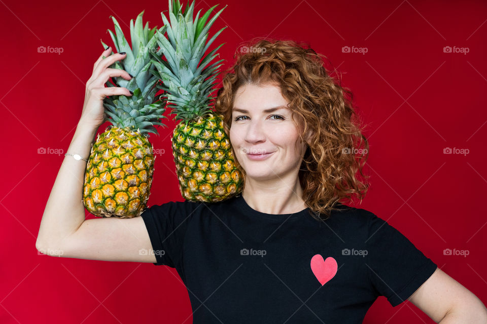 beautiful red-haired girl with pineapple with cool emotions