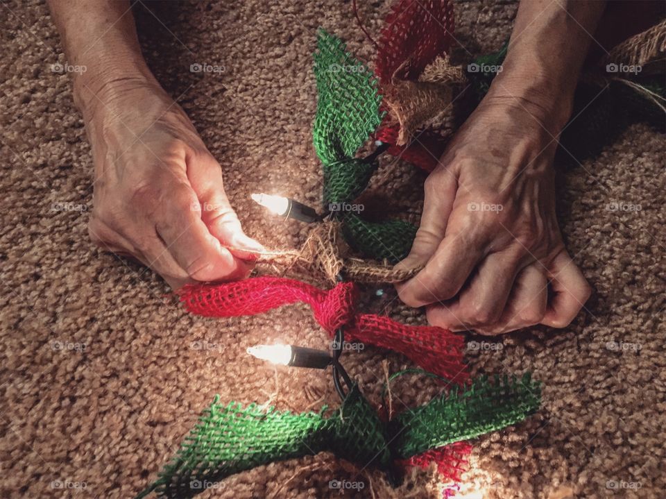 Making burlap garlands out of Christmas lights 