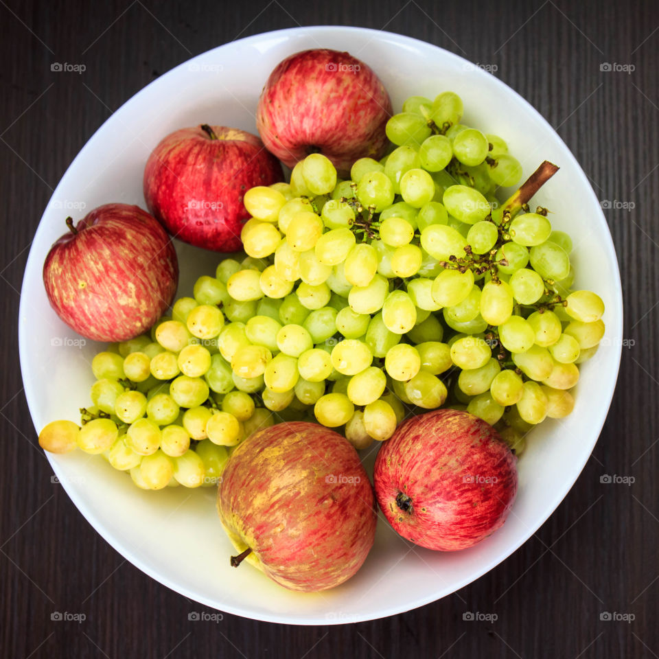 Grapes and apple on plate
