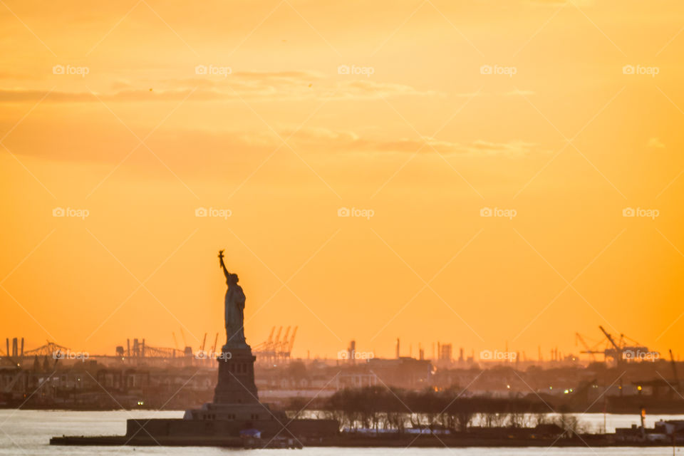 The Statue of Liberty at warm sunset 