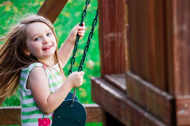 little girl swinging