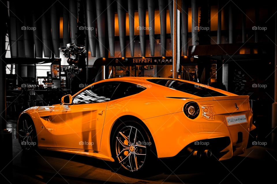 Car show in dubai mall. Orange Ferrari on a black background