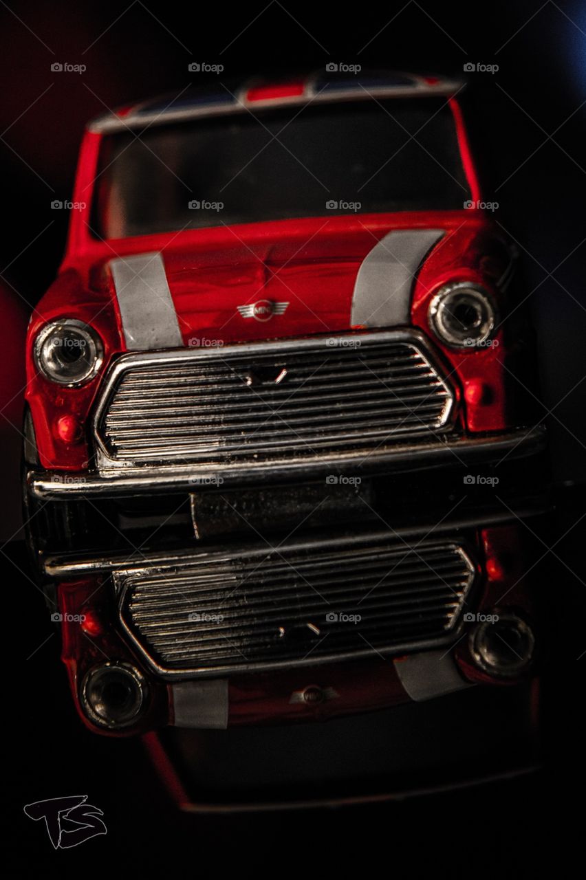 Toy Car Mini Cooper short on a Nikon D3300 again a laptop screen and reflective background 