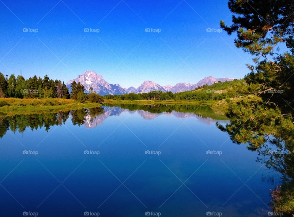 Scenic view of blue sky reflecting on lake