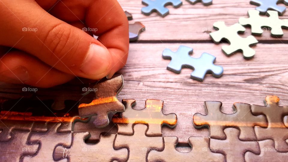 Boy holding jigsaw puzzle