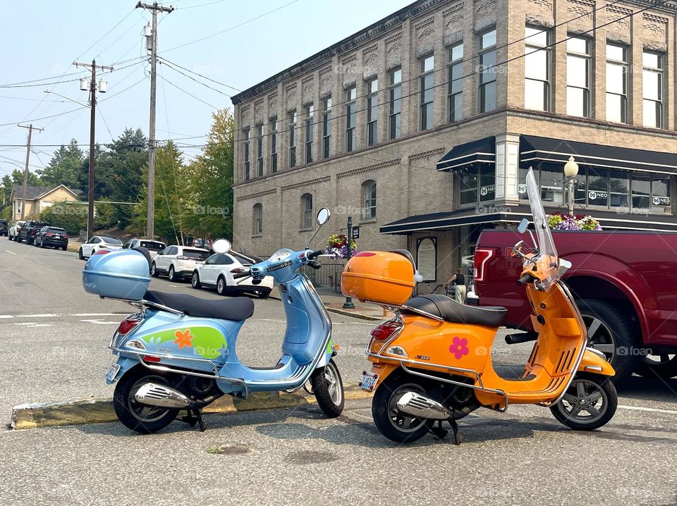 Blue and orange scooters at the street 