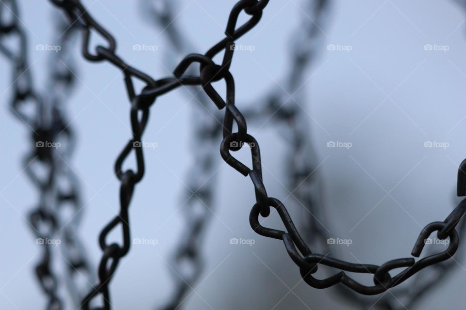 Dark, old, basketball hoop chains, left outside in the cold on one particular dusk night.