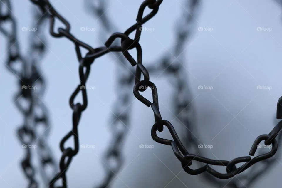 Dark, old, basketball hoop chains, left outside in the cold on one particular dusk night.