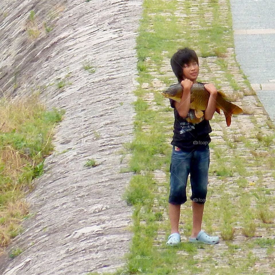 young boy and fish in Kyoto