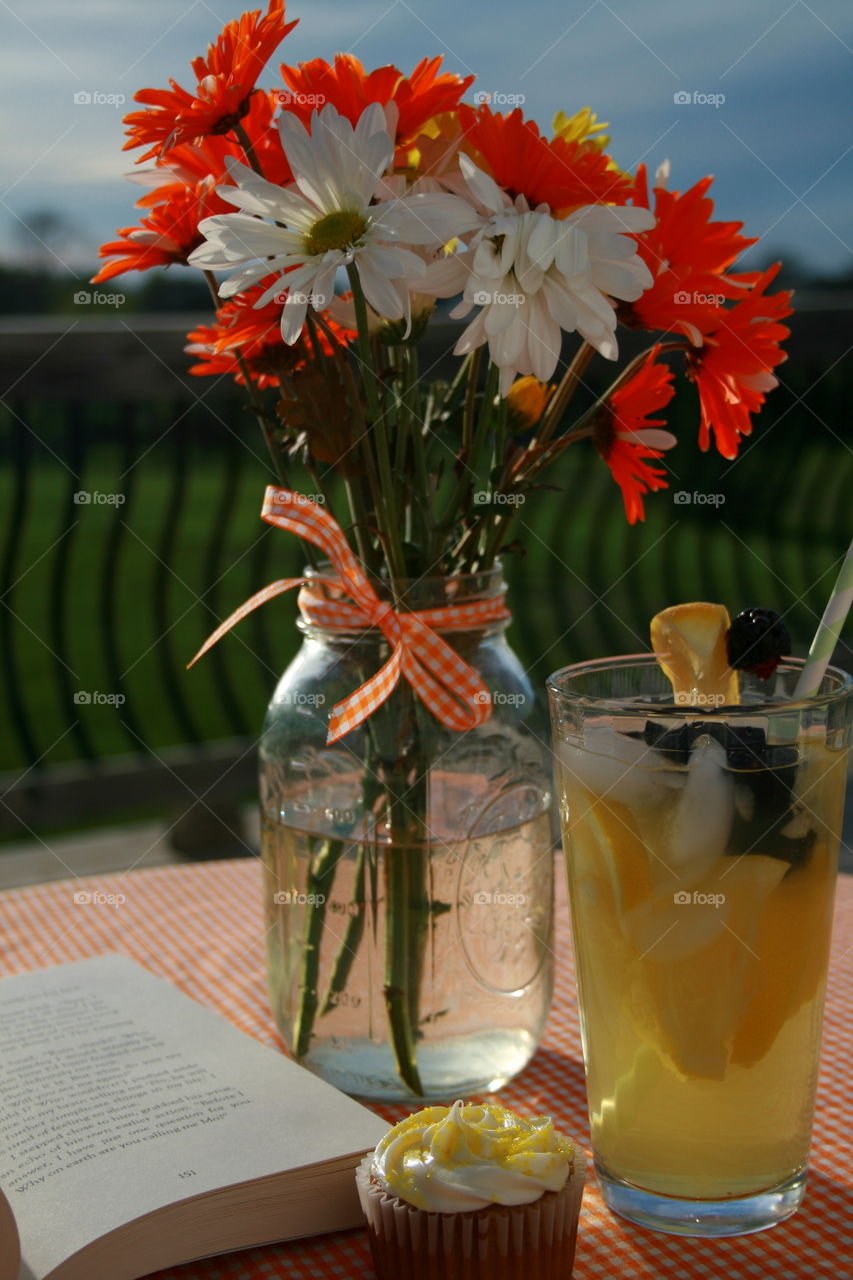 Perfect Afternoon . A glass of lemonade, a good book and cupcake on a beautiful day! Love days like this!