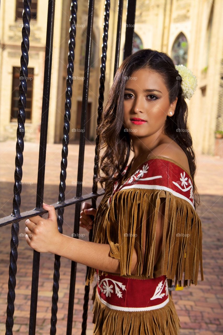 Cute girl in a leather traditional mexican outfit