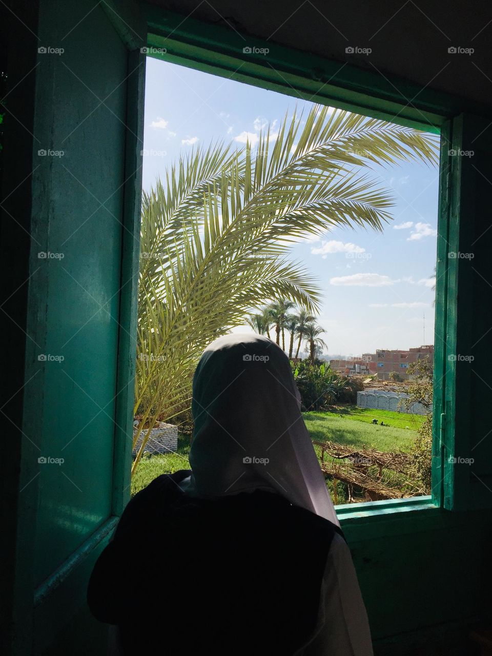 A girl is looking from a window