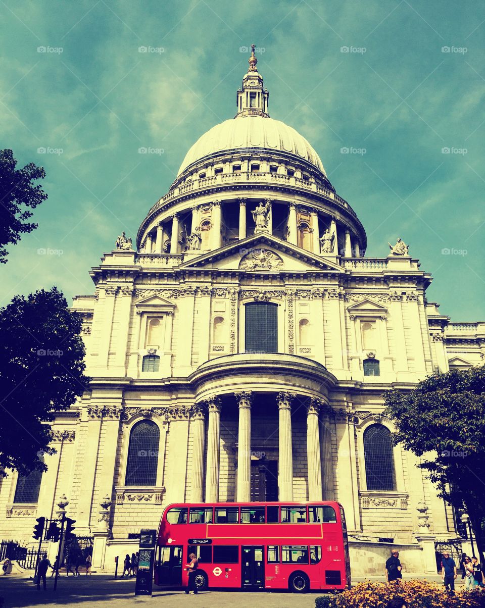 St Paul’s Cathedral in London with a red double decker tour bus in front 