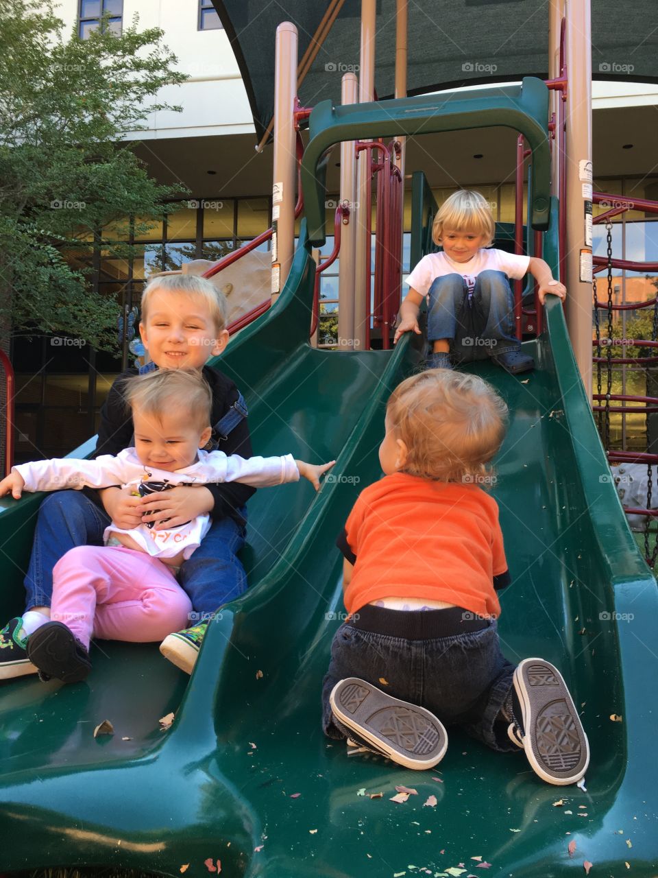 Children playing slide in park