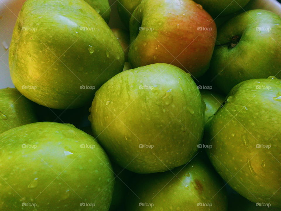 drops of water on green apple varieties of simirenko