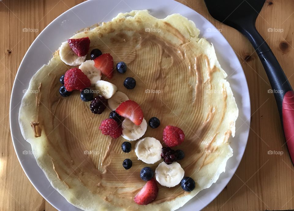Crepe with peanut butter, blueberries, strawberries, bananas, blackberries, and raspberries