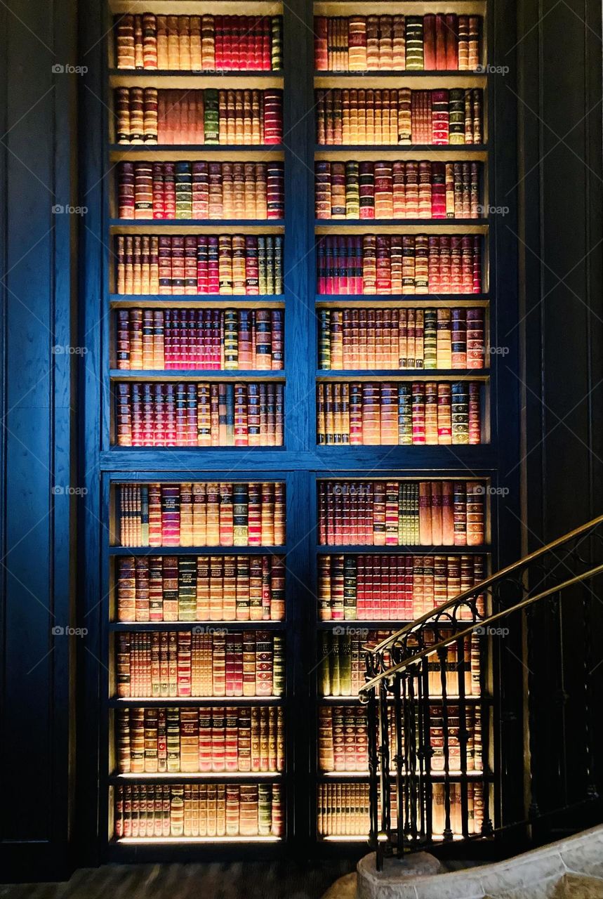 A wall of books at the bottom of the stairs.