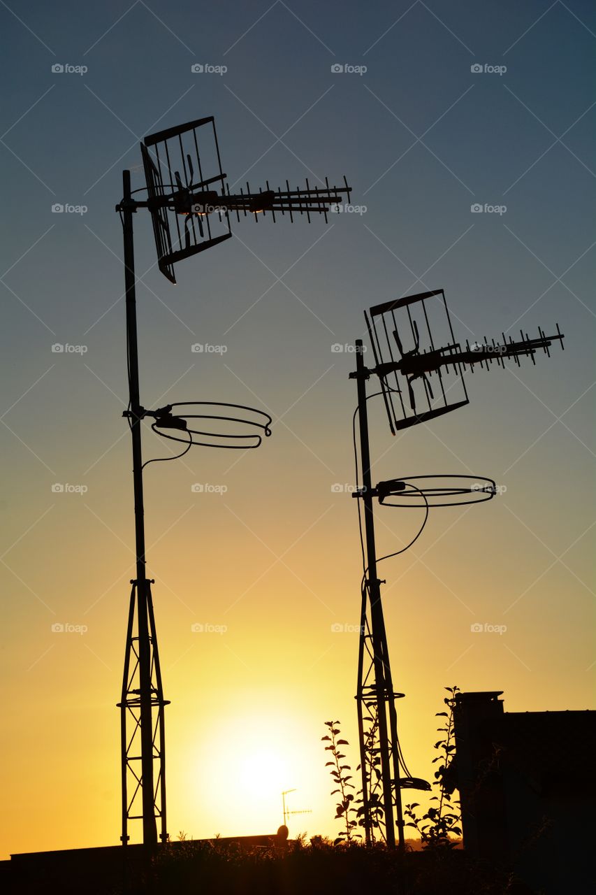 two antennas and a beautiful sunset
