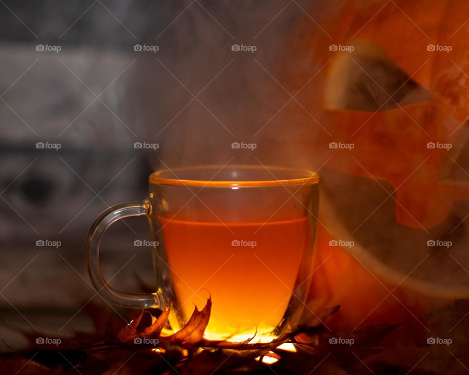 Steam glass cup of apple cider in a Fall setting