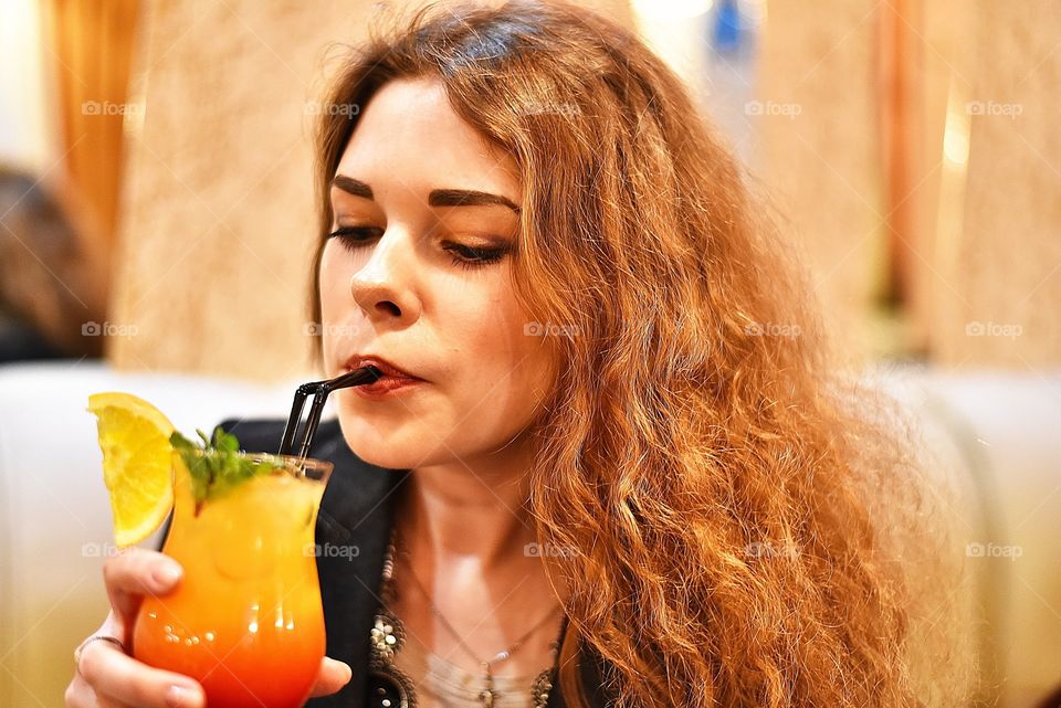 Woman drinking cocktail juice