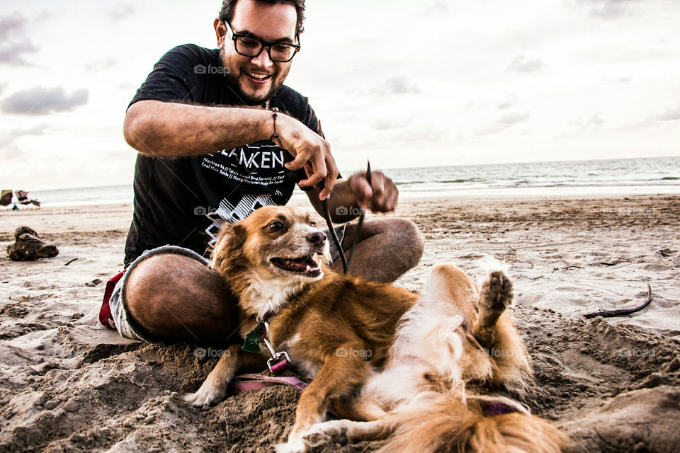Playing with a dog at the beach