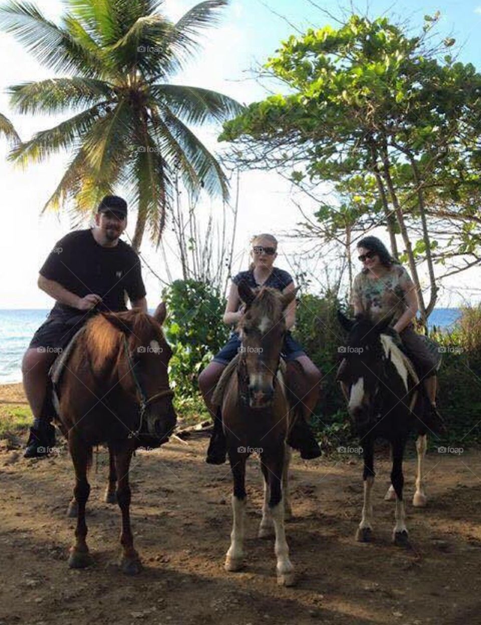 Horseback riding on the beach and amongst the Palm trees in Rincon, Puerto Rico. 