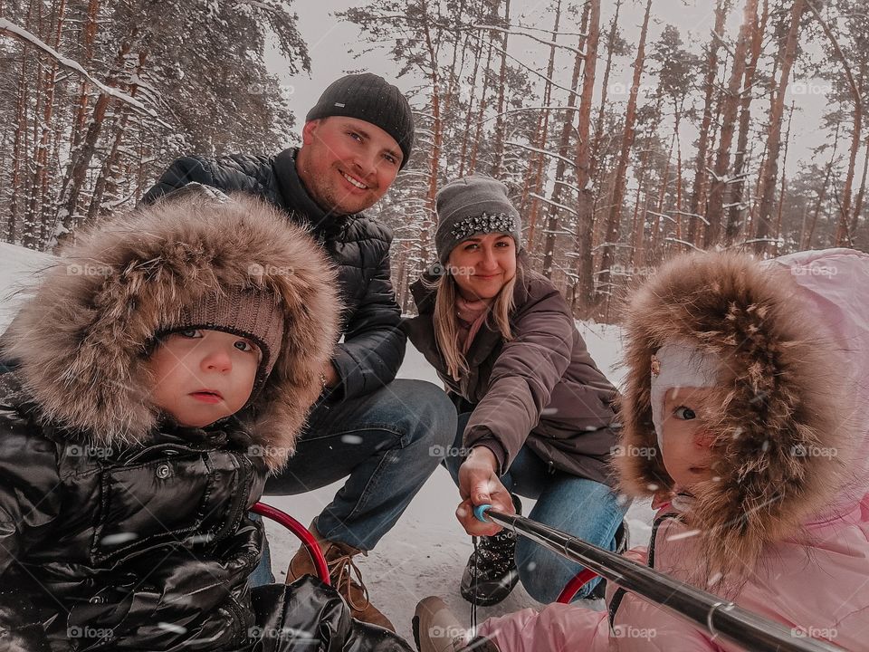 family walk in the winter pine forest