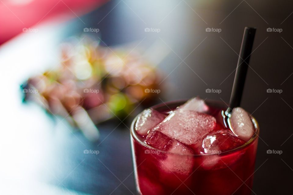 Close-up of cocktail with defocused lollipops in the background