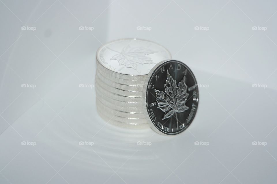 Pile of Canadian silver coins with maple leaf dollar