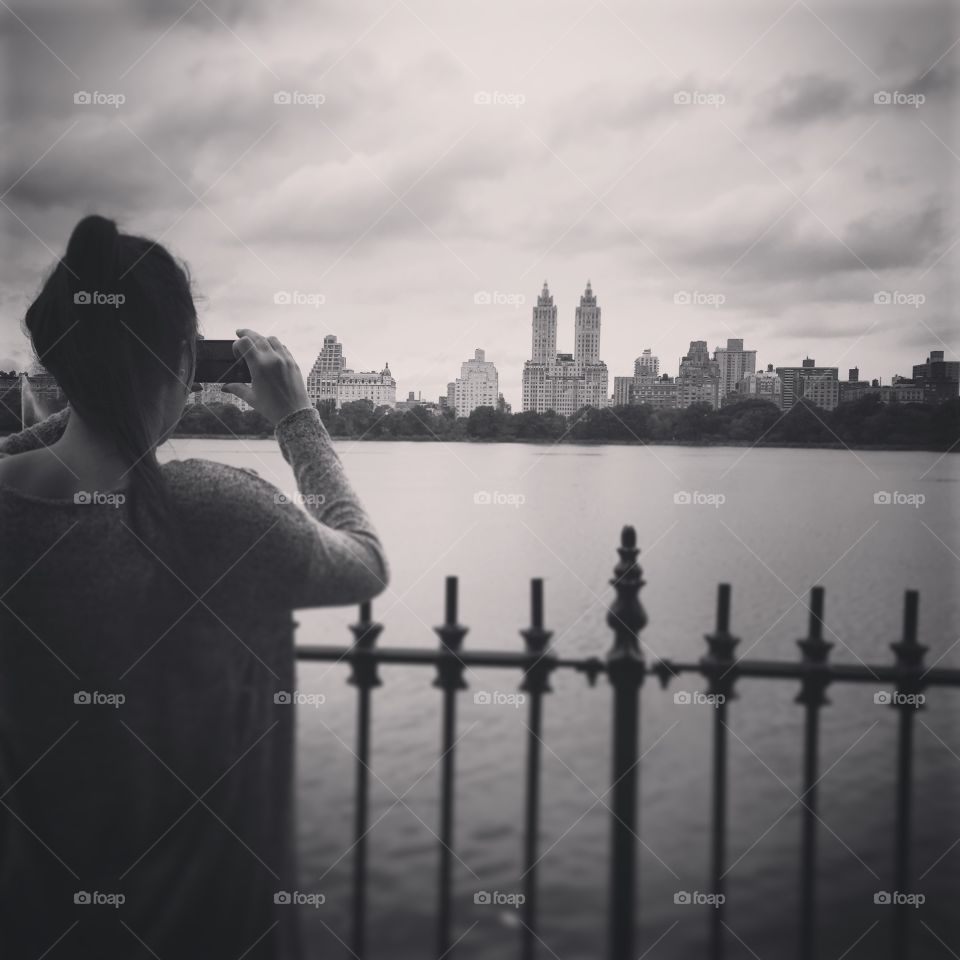 Central Park. A picture of my girlfriend taking a picture of the skyline of New York above Central Park 