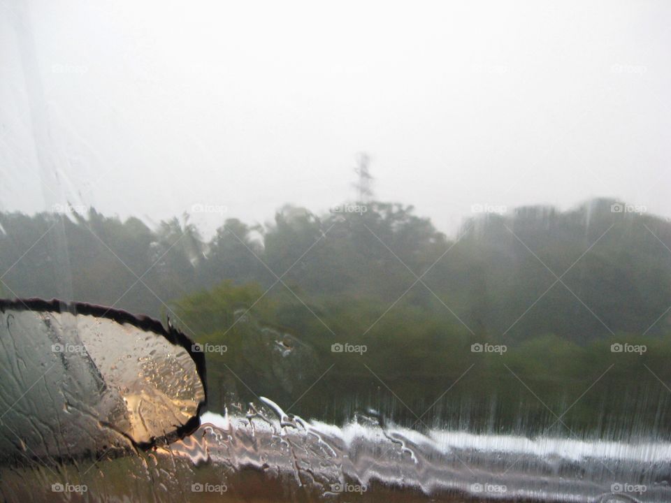 A rainy day through the passenger's side window