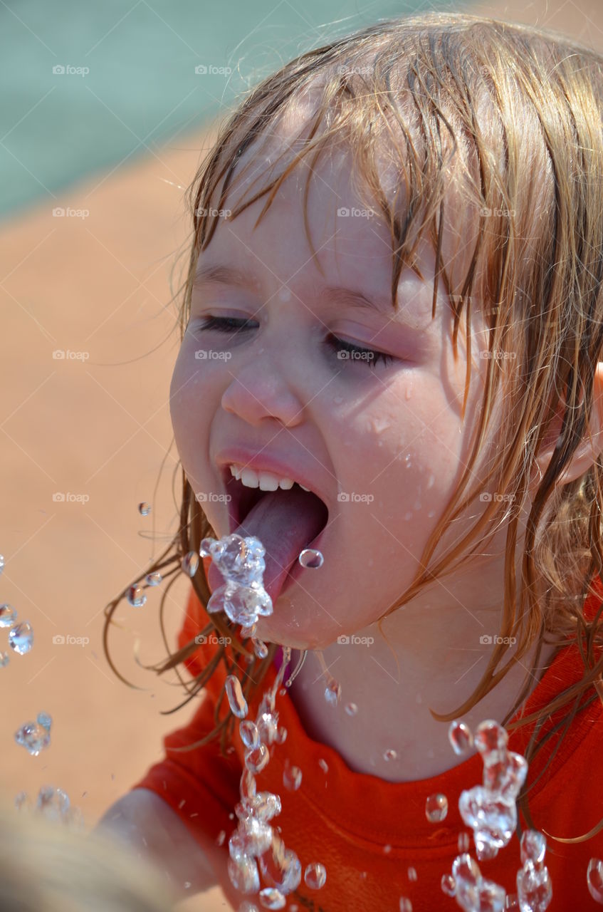 Close-up of girl with sticking out tongue
