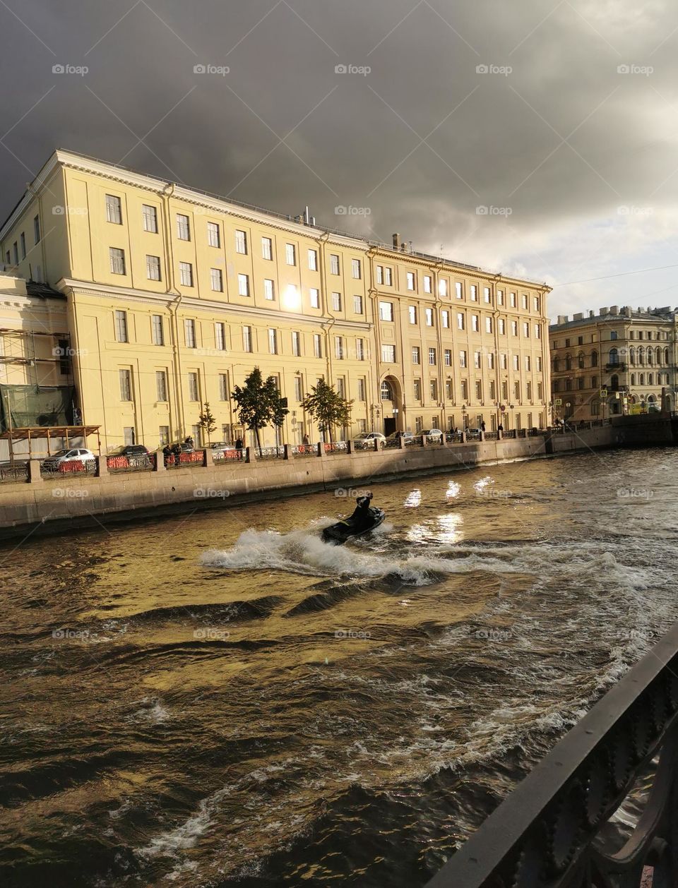 A guy on a scooter on the river