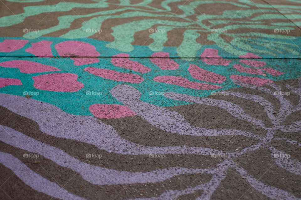 Colourful artwork is on full display on a sidewalk intersection in a nearby village known for its vibrant public art.  