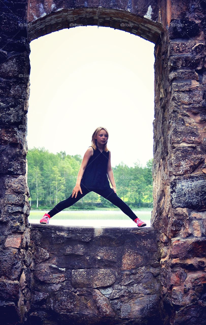 Girl in a window. Girl in old ruin window