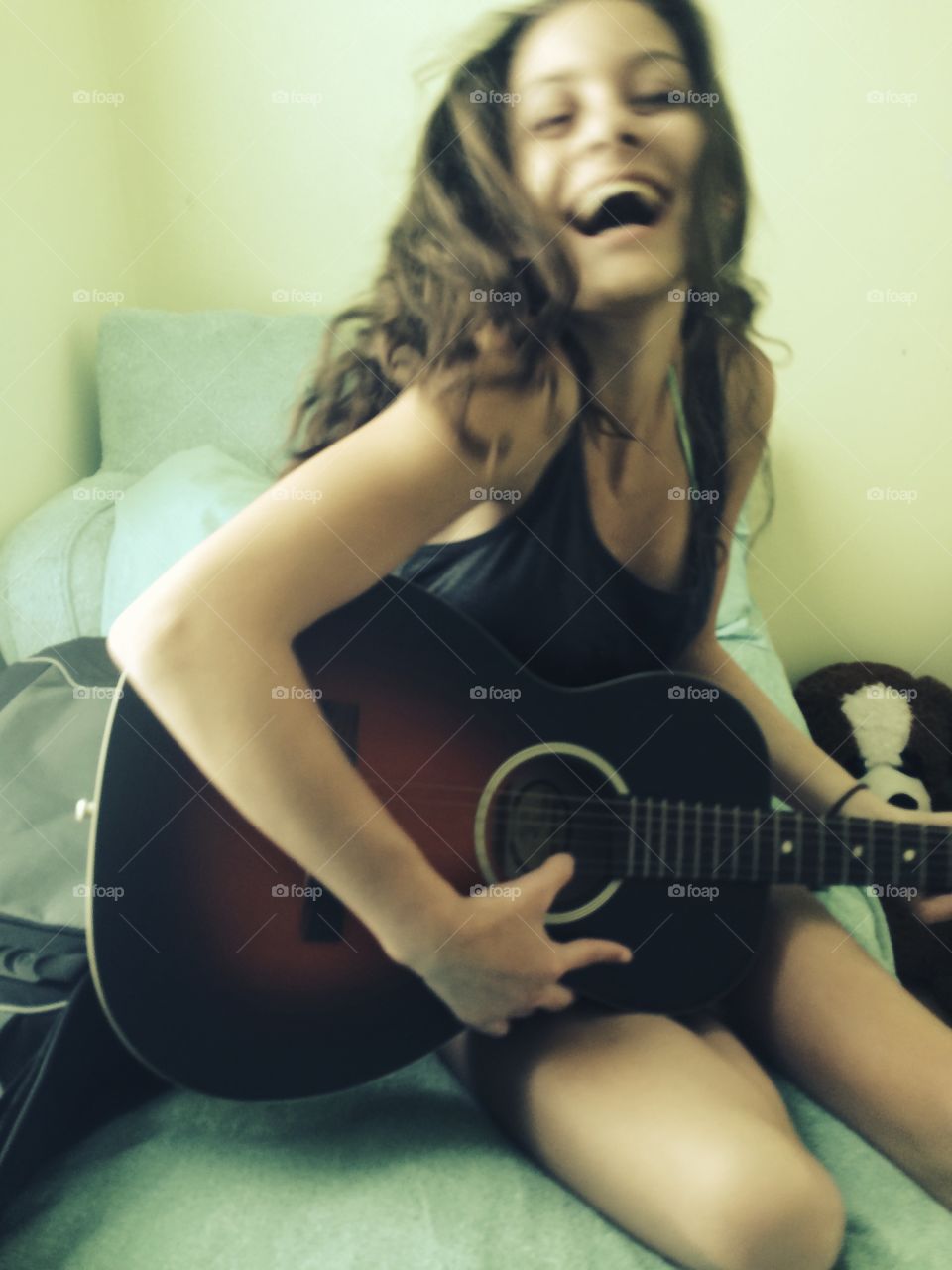 Smiling woman playing guitar