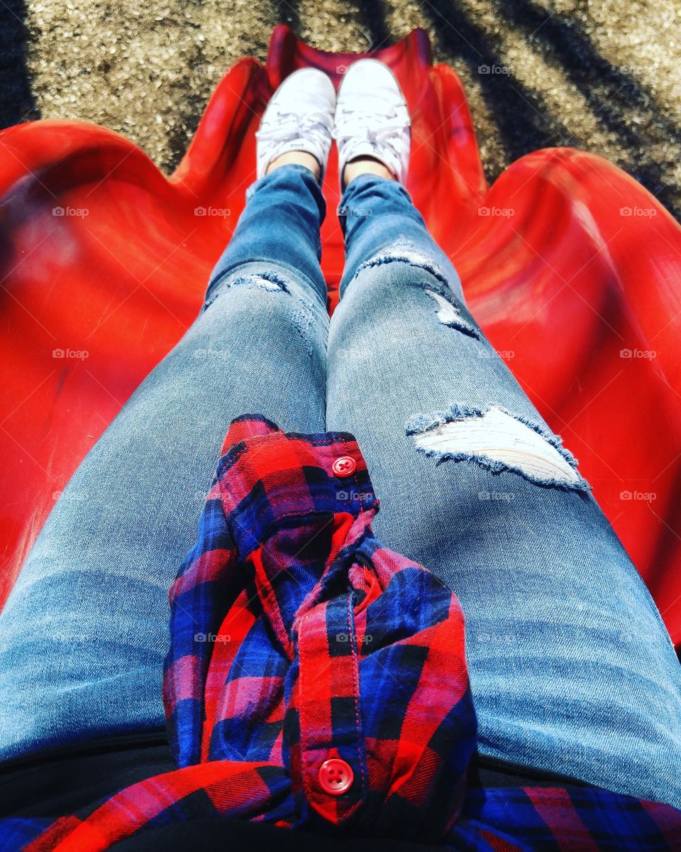 Close-up of a woman's foot on red slide