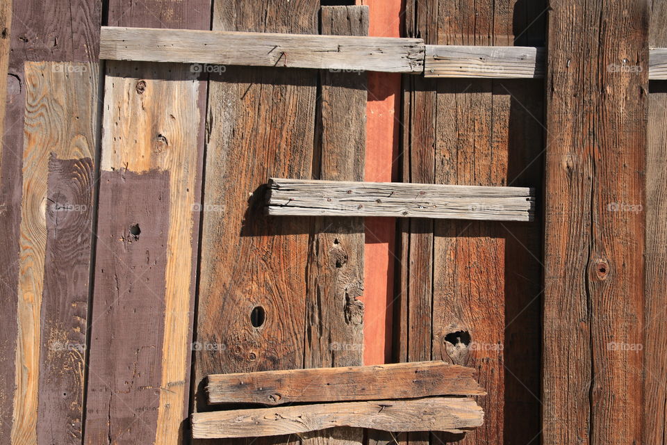 Old weathered wood door closeup, suitable for wallpaper, desktop, background, rustic theme 