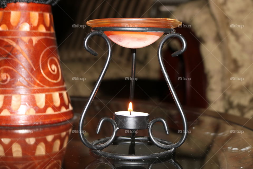 Oil burner with lighted tea candle