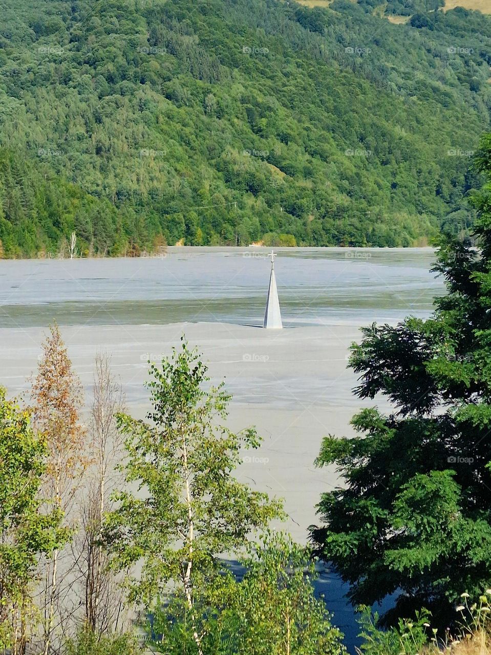 the village of Geamana, the submerged village in the Apuseni mountains where only the church spire can be seen