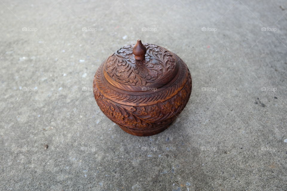 traditional old-fashioned wooden pot with carved floral design