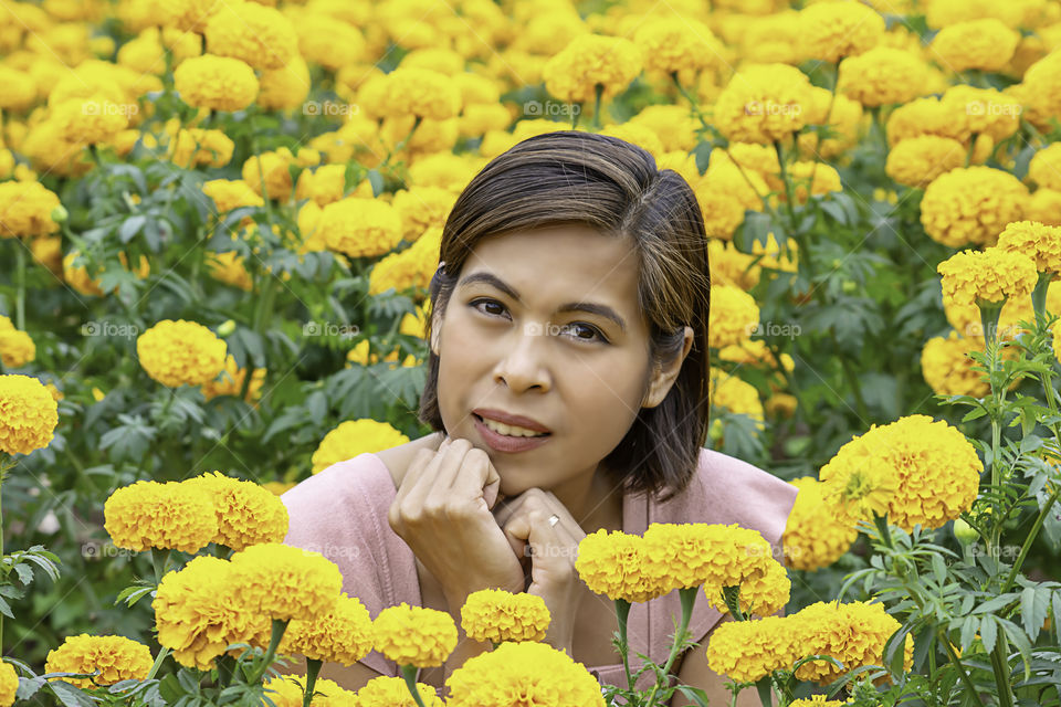 Woman in Yellow Marigold flowers garden or Tagetes erecta at Phu Rua, Loei in Thailand.