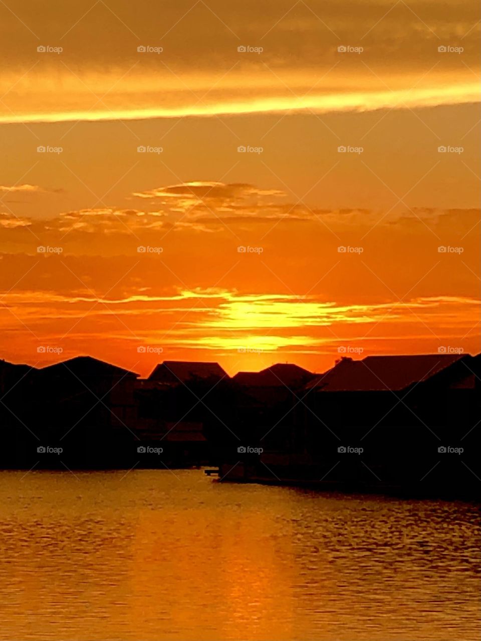 Same sunset. Orange sky making beautiful silhouettes of the houses on the canal in Texas. 