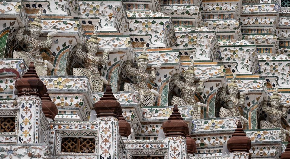 Beautiful Symmetry composition and leading line of Giant statue make the famous pagoda of Temple of Dawn (Wat Arun) is very interested for tourists , Bangkok Thailand
