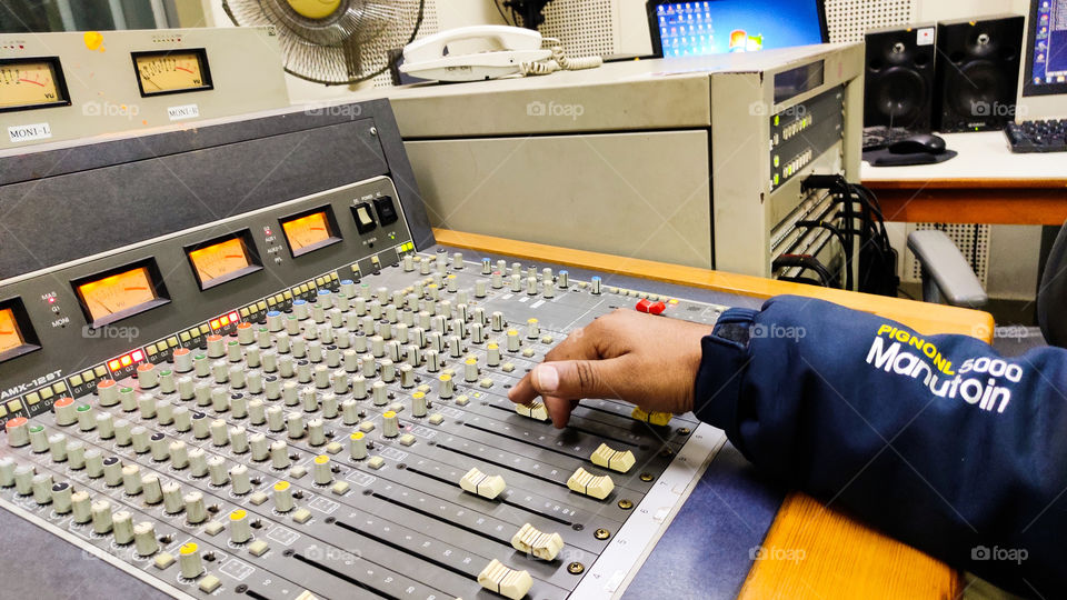 audio technician operating feeder panel