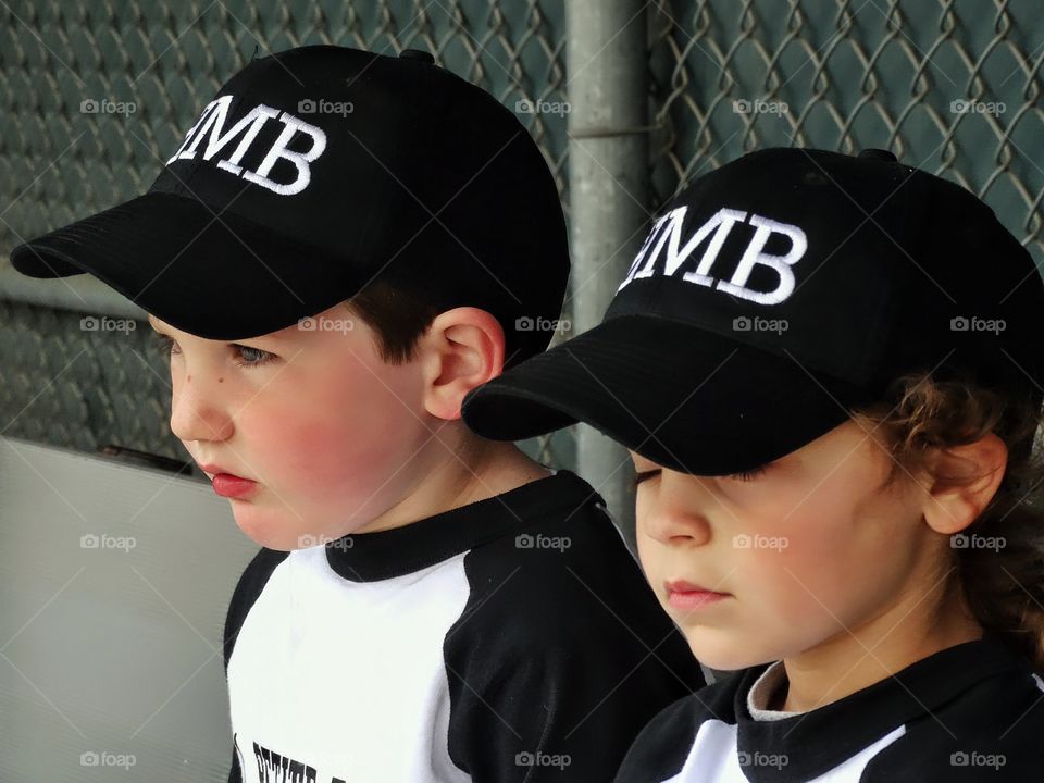 Young Baseball Players. Young Boy And Girl In Little League Baseball Uniforms
