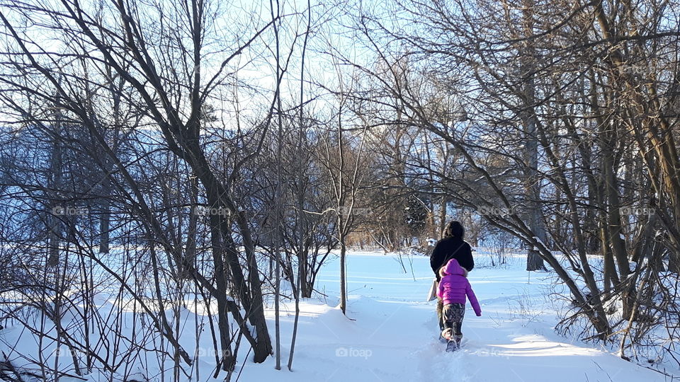Father and Daughter Stroll Through The Woods